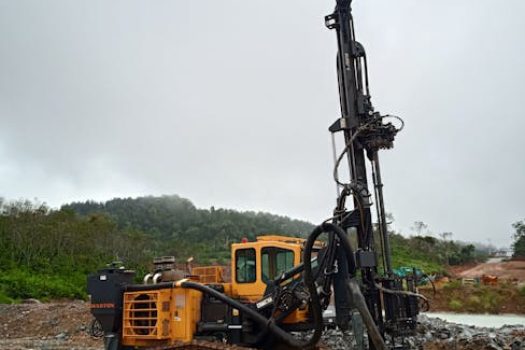Vertical shot of construction equipment in a muddy site at Simpenan, Indonesia.
